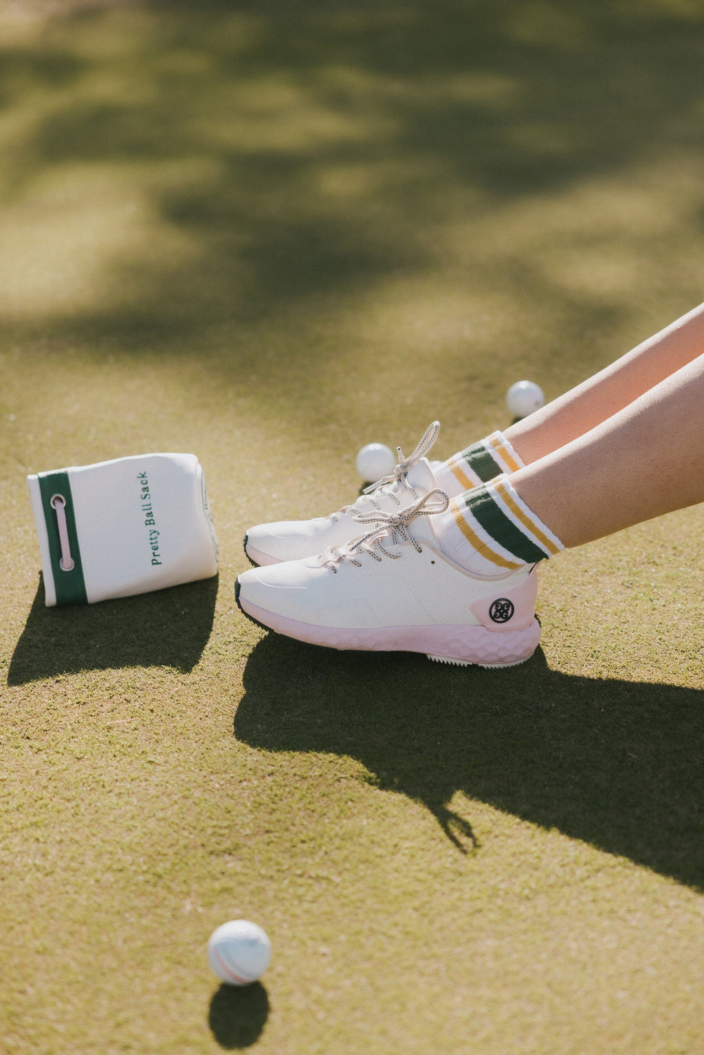 A person wearing retro ankle socks in mustard and green colors, paired with a white shoe.