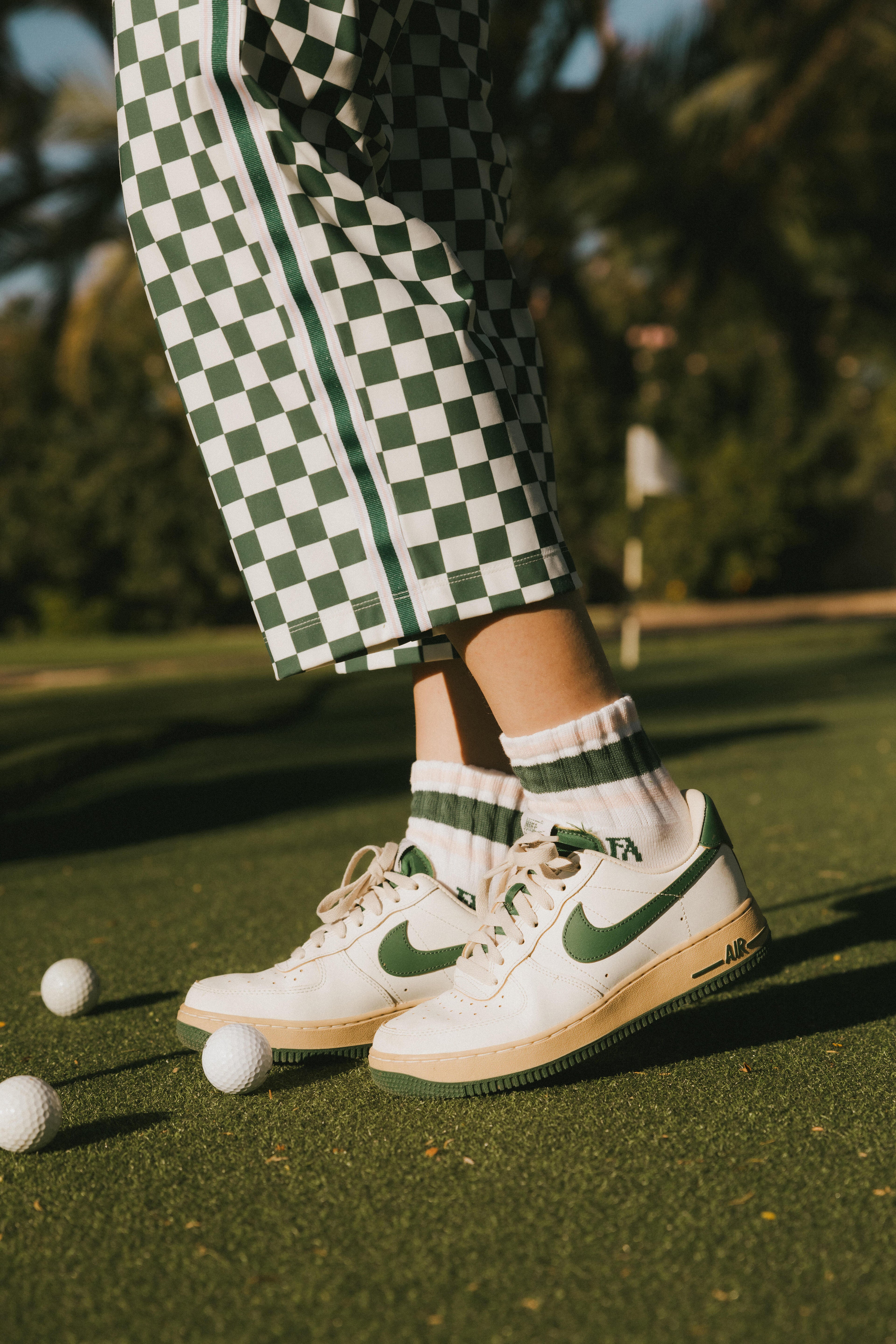A model wearing a pink and green striped retro ankle sock.