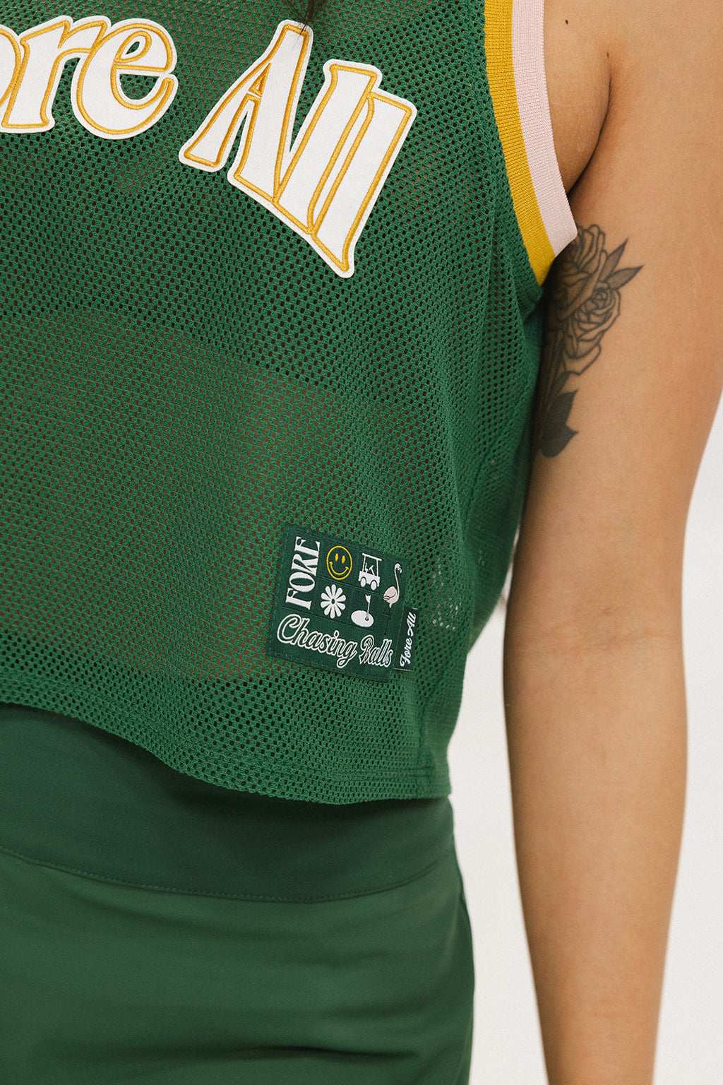 This image features the "Ace Tank Top" in a vibrant green color, highlighted by its sporty and breathable design. The tank top is sleeveless, emphasizing a casual yet athletic style suitable for various activities.