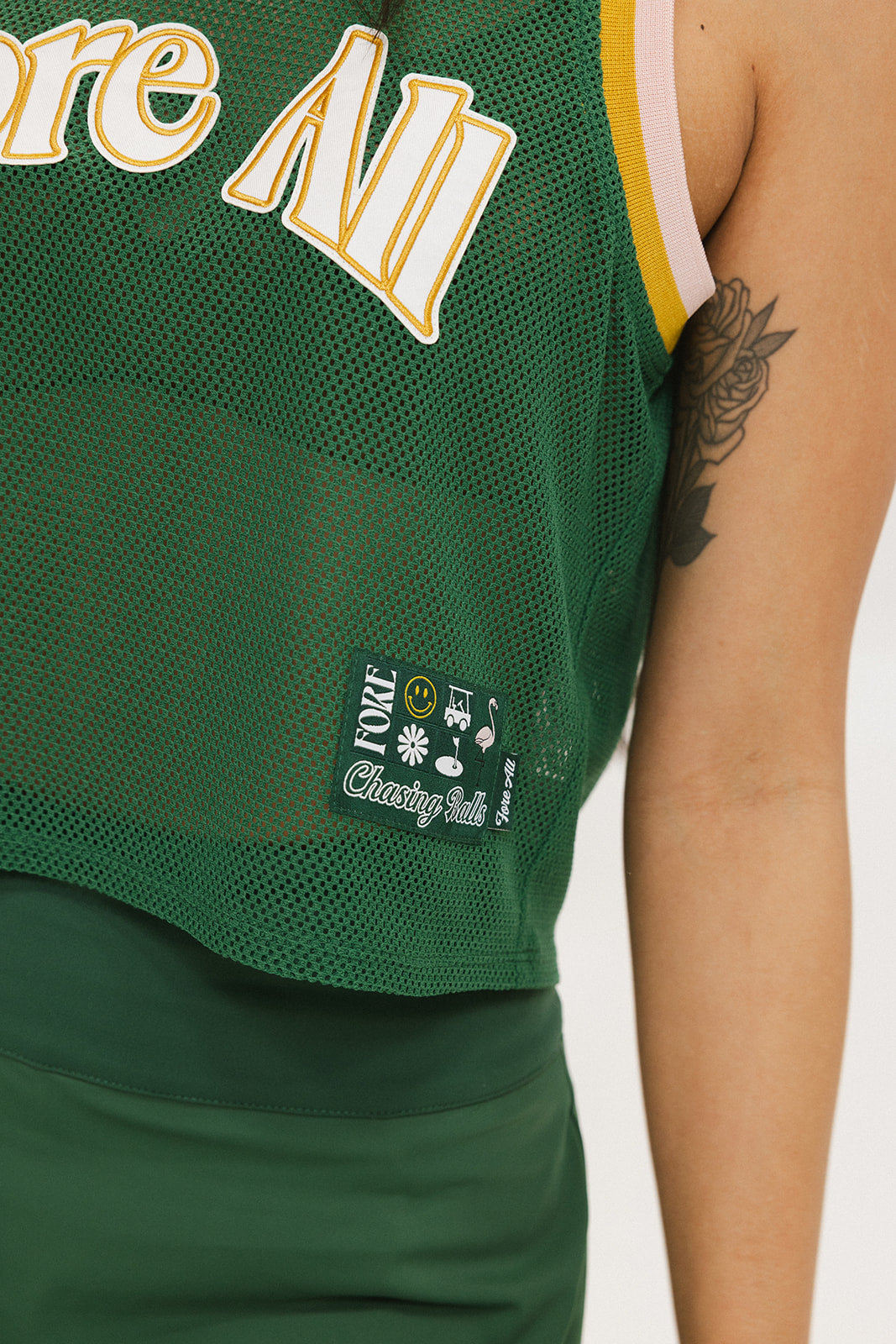 This image features the "Ace Tank Top" in a vibrant green color, highlighted by its sporty and breathable design. The tank top is sleeveless, emphasizing a casual yet athletic style suitable for various activities.