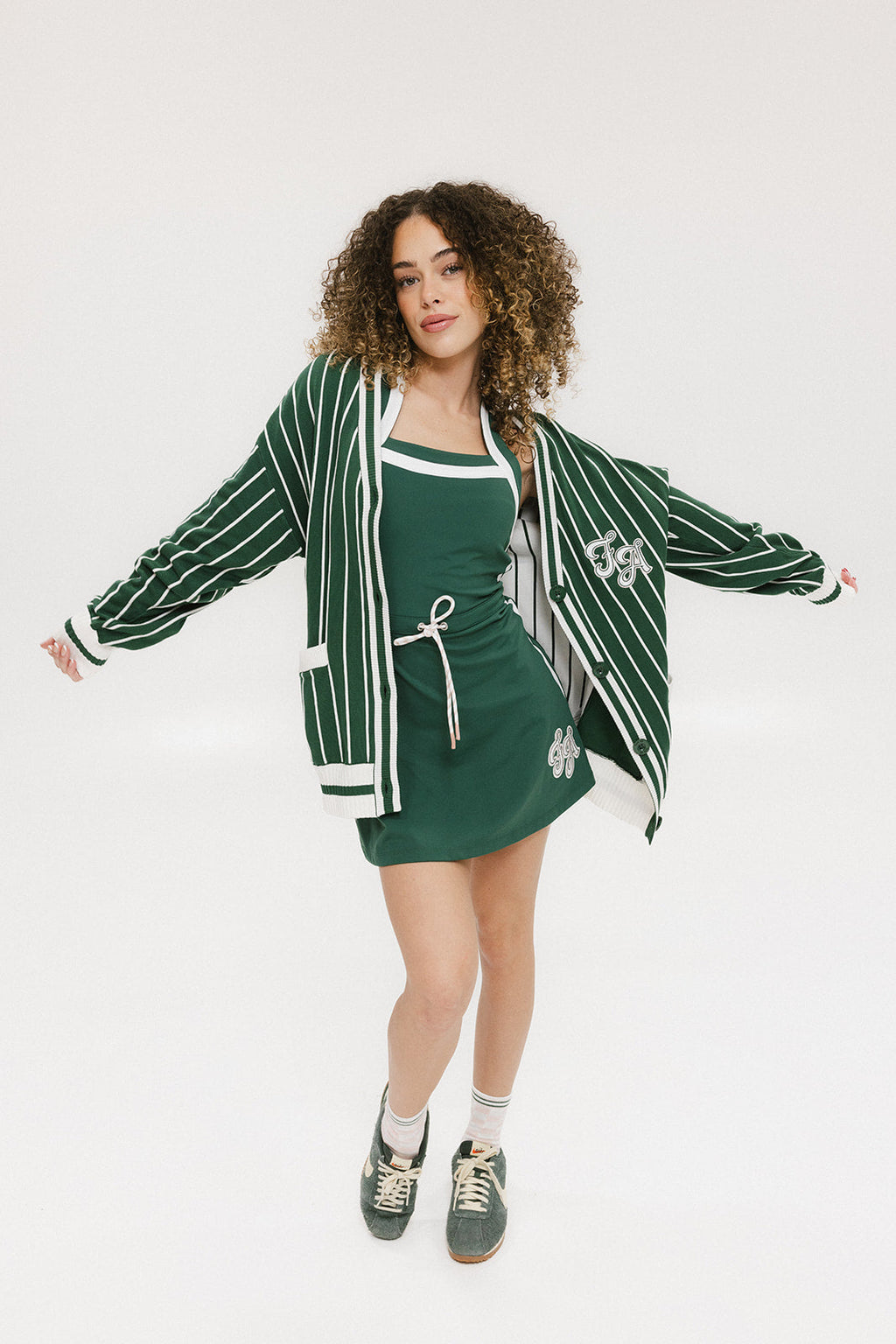 Person wearing a green and white striped cardigan with 'Chasing Balls' text.