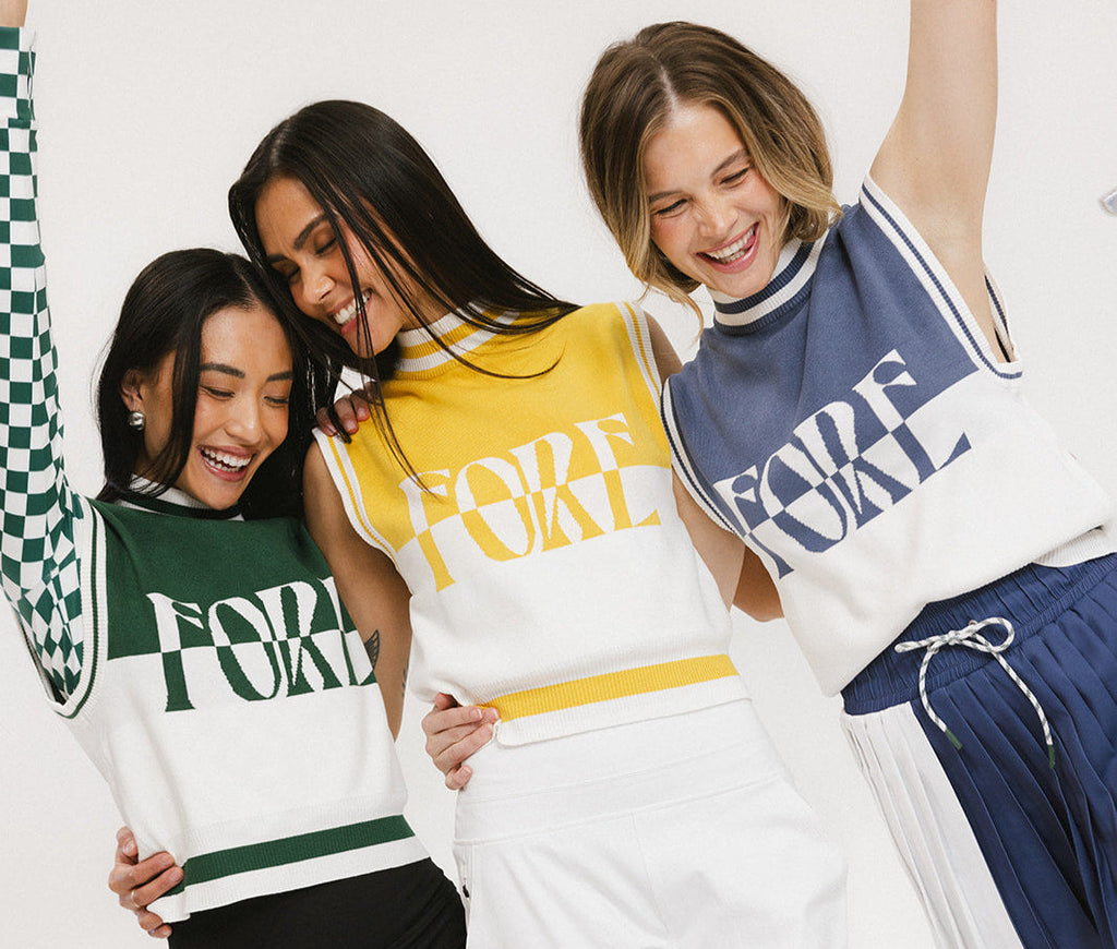 Three models wearing a sleeveless mock-neck sweater with intarsia knit design, featuring horizontal green, mustard, and indigo stripes and the word 'FORE' printed across the chest.