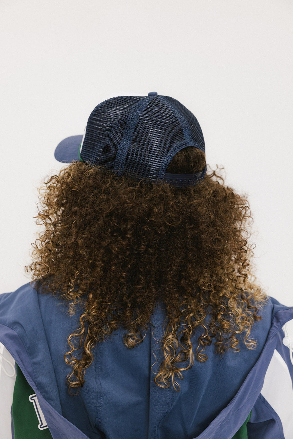 A model wearing an indigo and white hat with the text 'DOUBLE BOGEYS ARE HOT' on the front