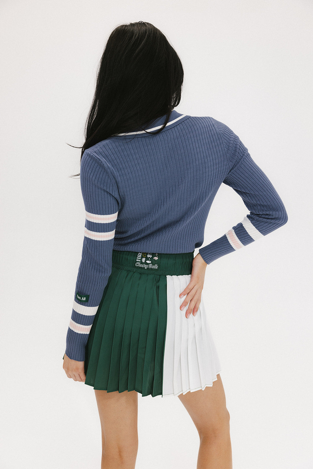 This image features the Alice Ribbed Keyhole Polo in a striking indigo color. The polo is designed with a classic ribbed texture that enhances its visual appeal.