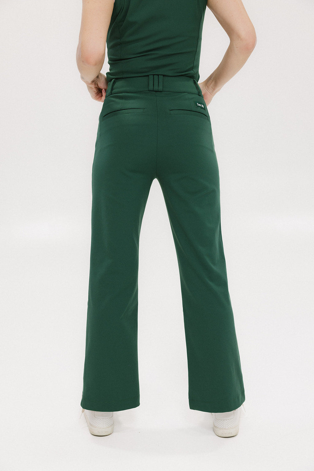 A pair of green Simone Pant with white stripes on the side, front and back pockets, and a zipper fly with snap closure.