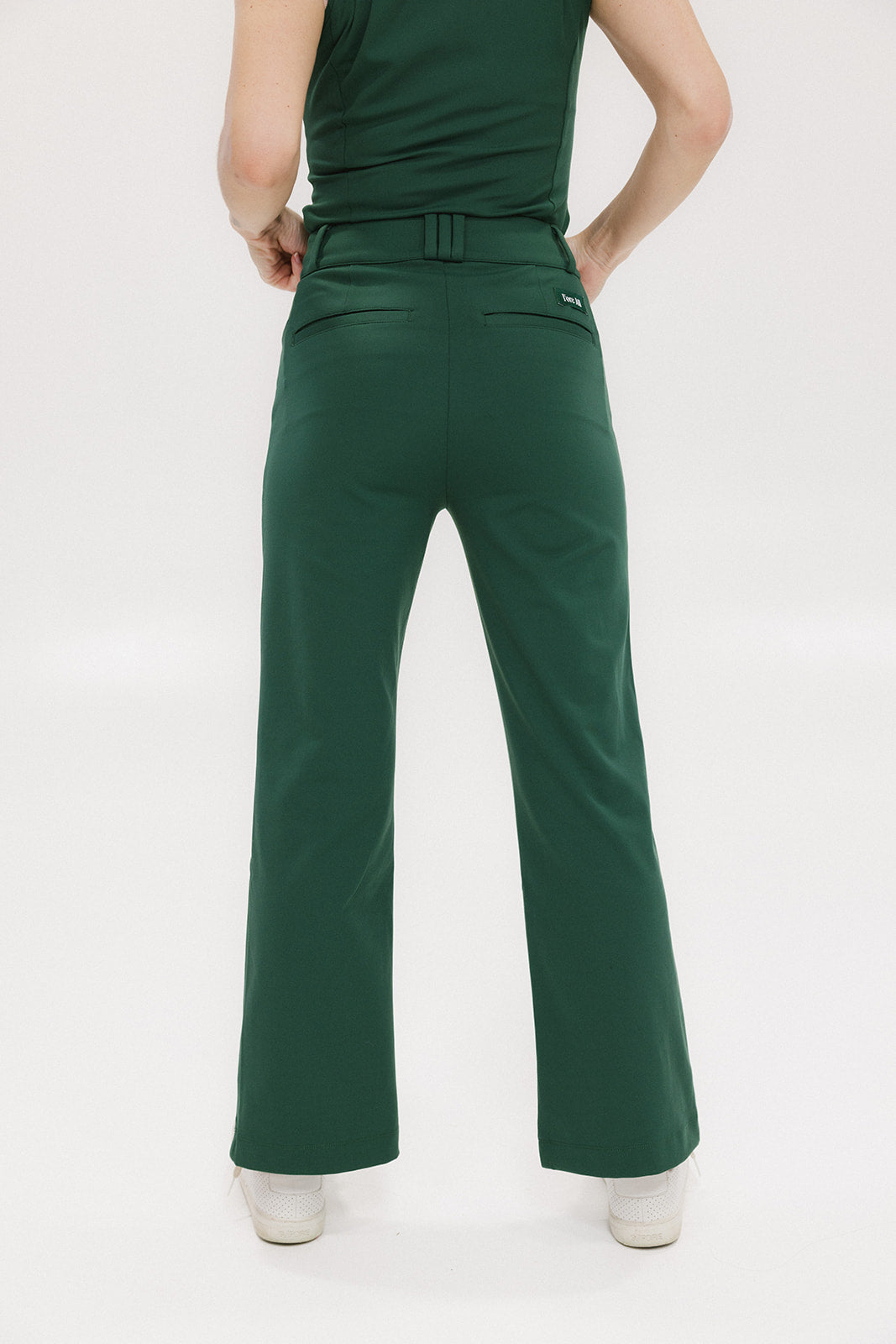 A pair of green Simone Pant with white stripes on the side, front and back pockets, and a zipper fly with snap closure.