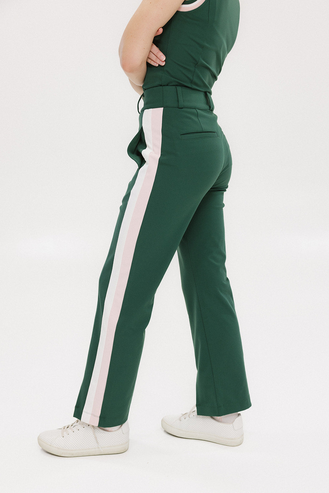 A pair of green Simone Pant with white stripes on the side, front and back pockets, and a zipper fly with snap closure.