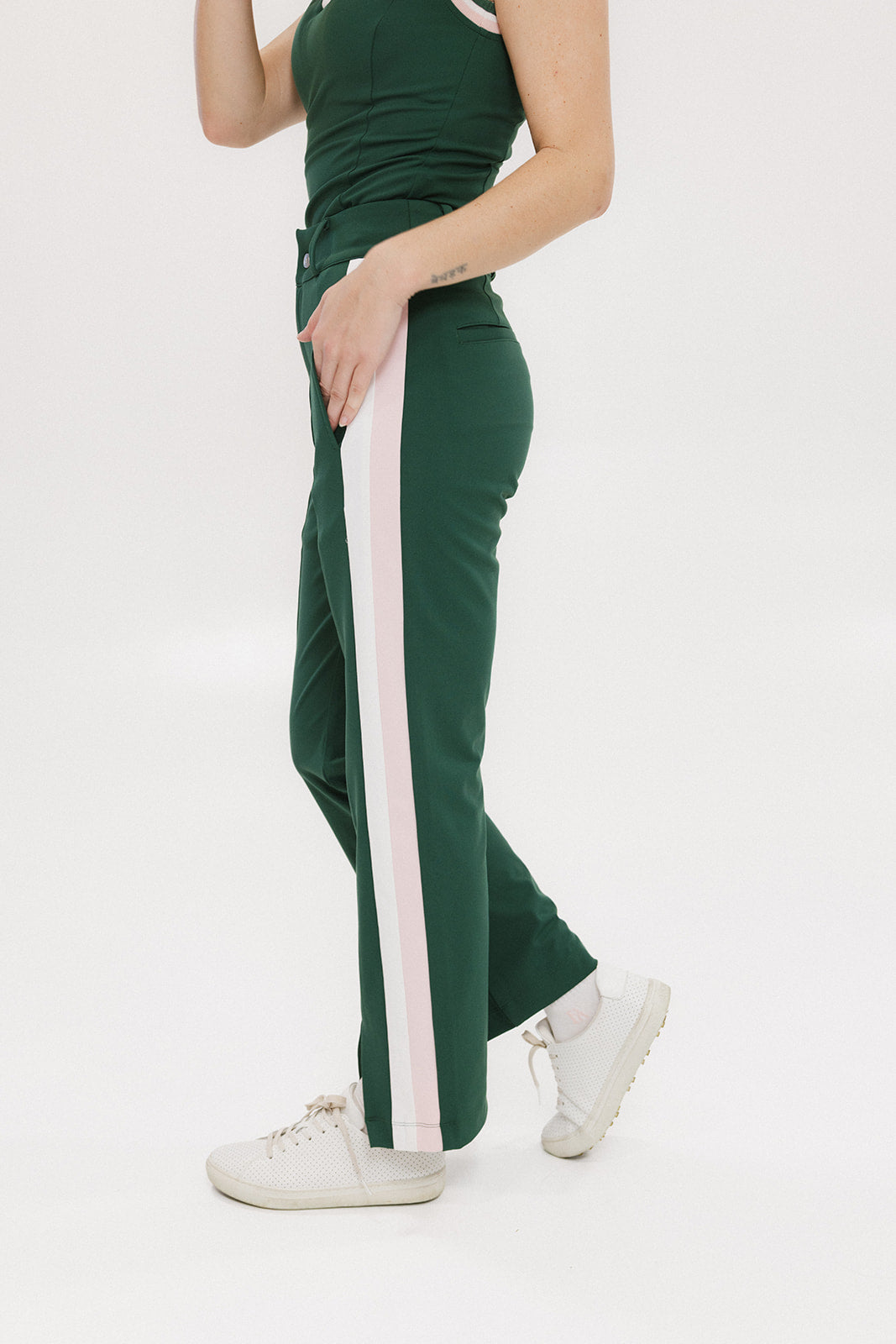 A pair of green Simone Pant with white stripes on the side, front and back pockets, and a zipper fly with snap closure.