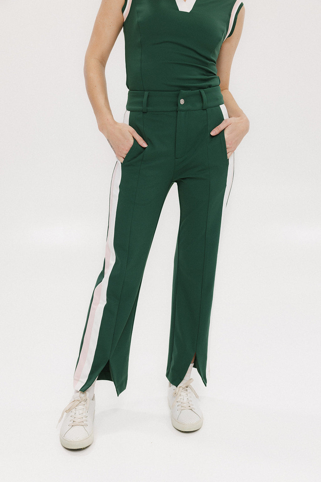 A pair of green Simone Pant with white stripes on the side, front and back pockets, and a zipper fly with snap closure.